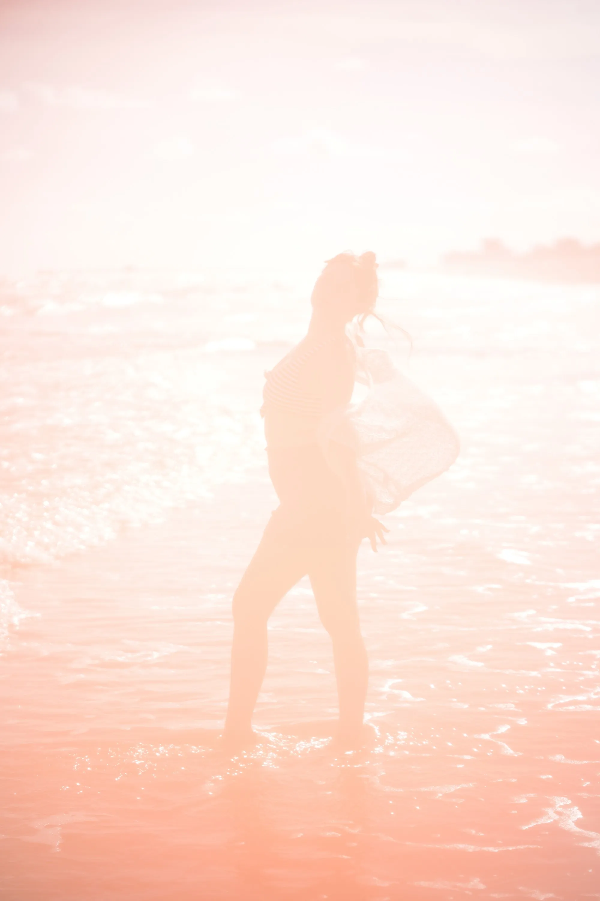 Overexposed pastel portrait by the shore — lace, sand and backlight — 7